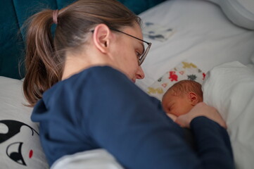 Closeup of mother breastfeeding her newborn baby child