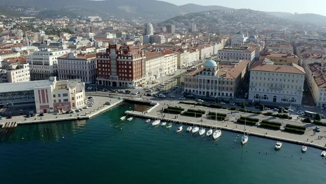 aerial drone shot of trieste city center from the sea on the canal grande ponterosso with hills in background