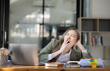 Asian businesswoman are stressed and tired from work sitting at desk in the office, feeling sick at work, stress from work. 