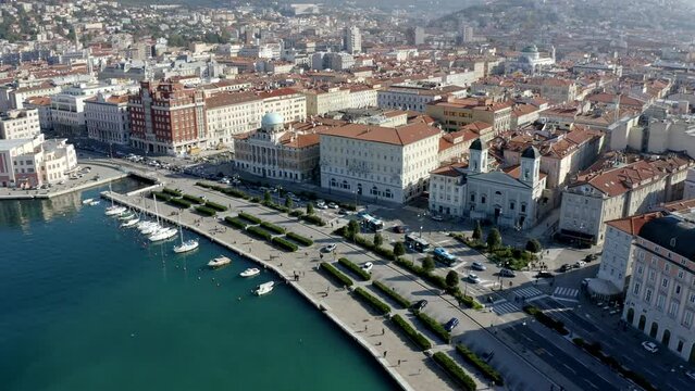 aerial drone shot of trieste city center from the sea on the canal grande ponterosso with hills in background