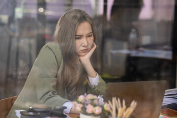 Asian businesswoman are stressed and tired from work sitting at desk in the office, feeling sick at work, stress from work. 