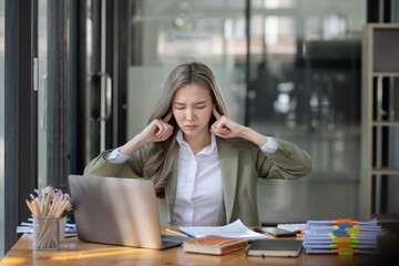 Asian businesswoman are stressed and tired from work sitting at desk in the office, feeling sick at work, stress from work. 