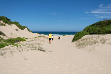 people walking towards the sea in a hidden beach