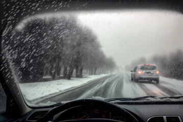 Car driving in snow. Travel in a storm, snowy asphalt road, Generative AI