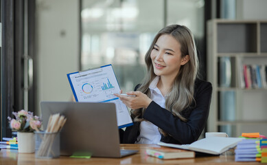 Fototapeta premium Cheerful asian businesswoman working at table office. 