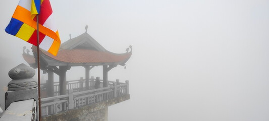 Canopy in the form of a pagoda on a panoramic balcony in mystical fog on Fansipan mount. Another name is Phan Xi Pang mountain, the highest mountain in Vietnam. Sapa, Lao Cai province - obrazy, fototapety, plakaty
