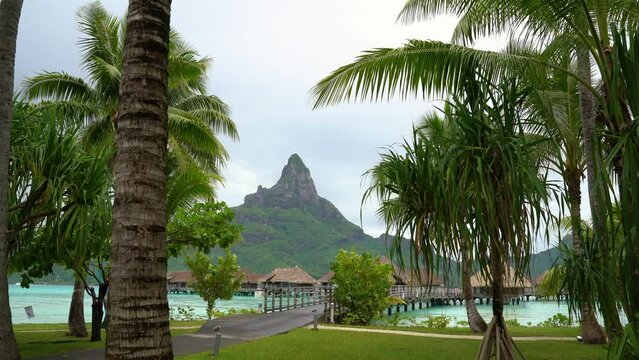 Bora Bora perfect beach overwater bungalow resort hotel and Mount Otemanu in Tahiti, French Polynesia in coral lagoon sea and Mt Pahia, Mt Otemanu, Tahiti, south Pacific Ocean.