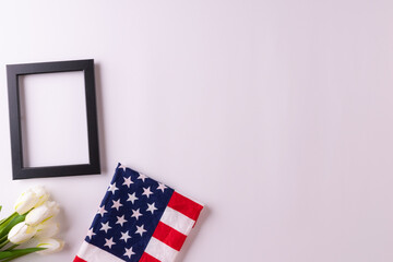 Happy presidents day concept with flag of the United States on white background with tulips for top...