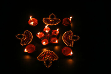 Beautiful diwali lighting, selective focus, Clay diya lamps lit during Diwali Celebration.