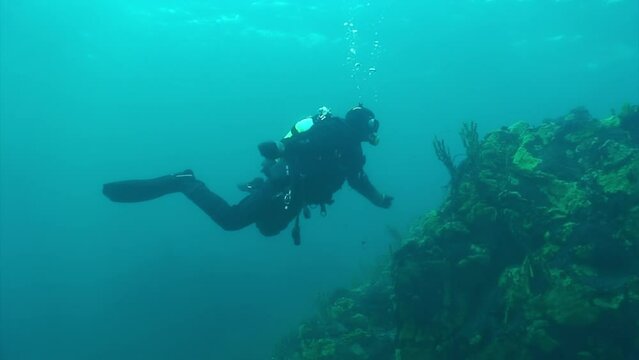 Researcher traveler diver on underwater bottom of Lake Baikal in Siberia Of Russia.