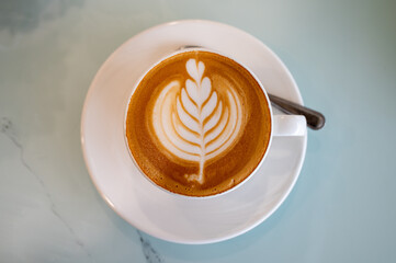Beautiful of Latte art coffee on tile table, flat lay
