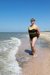 Senior woman posing on beach of Sea of Azov