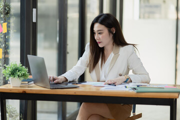 Asian businesswoman are stressed and tired from work sitting at desk in the office, feeling sick at work, stress from work.	