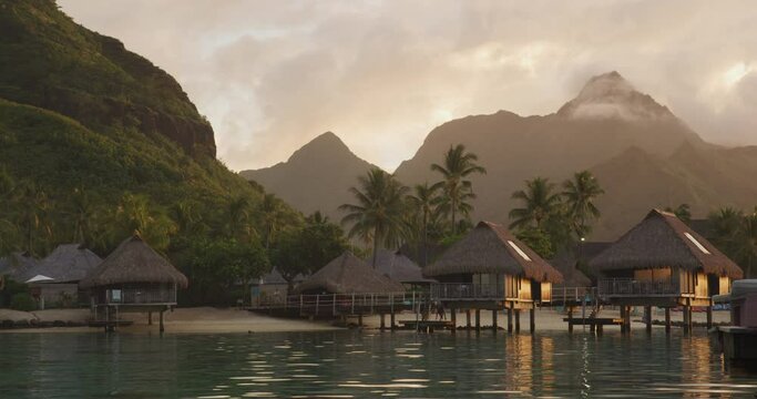 Travel vacation luxury resort hotel overwater bungalows on paradise beach. Romantic holidays destination on Moorea, French Polynesia. SLOW MOTION.