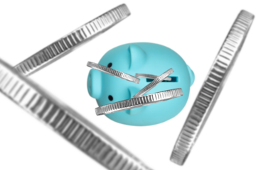 coins fall into piggy banks, top view