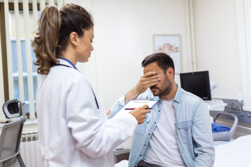 Fototapeta premium Patient receiving bad news, he is desperate and sad, Doctor support and comforting patient with sympathy. Don't worry, this medical test is not so bad