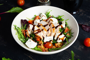 Fresh salad with chicken, tomatoes, herbs and feta cheese. Healthy food