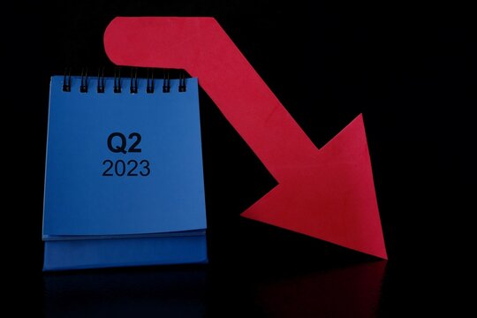 Second quarter of 2023 negative performance financial report and fiscal concept. Downward arrow with decreasing coins and calendar in black background.