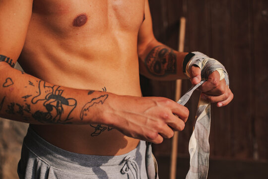 Boy putting bandages on his hands before a boxing match