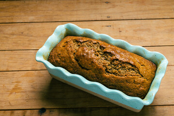 Pound cake in blue mold on wooden table. Homemade banana pound cake.