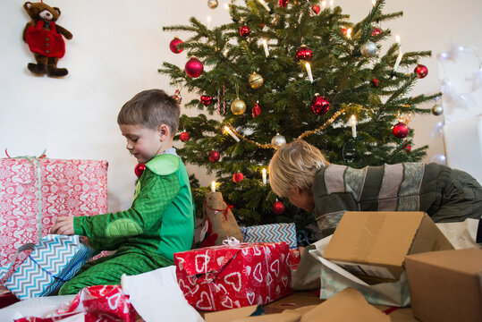 Children opening Christmas gift at home