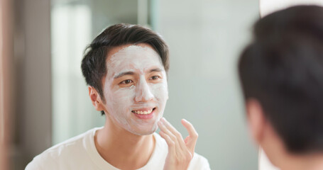 Asian man apply facial mask