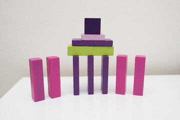 wooden multi-colored blocks on a white table. Educational games for toddlers and children. development of motor skills in children, environmentally friendly children's toys