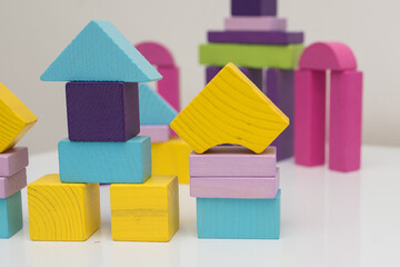 wooden multi-colored blocks on a white table. Educational games for toddlers and children. development of motor skills in children, environmentally friendly children's toys