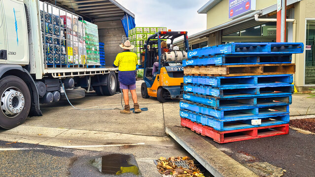 Forklift Driver and Truck Driver Unloading Liquor Truck at Yamba Liquor Store