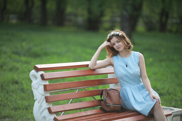 Girl in blue dress in green park