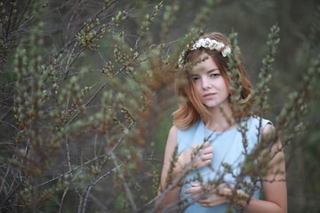 Girl in blue dress in green park