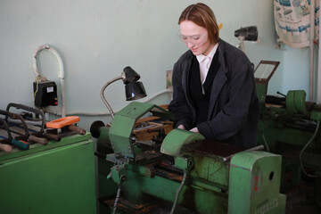 Young woman engineer working at machine tool