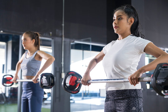 Asian Woman Sport, Bodybuilding, Lifestyle And People Concept - Young Asia Woman With Barbell Flexing Muscles And Making Shoulder Press Lung In Gym,healthy Fit Couple Lifting Barbells In The Gym