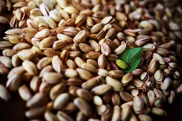 Roasted salted pistachios. Dried pistachios in small sack on  table.