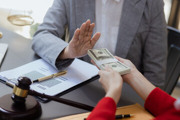 lawyer working with contract agreement at table office, lawyer holding money and justice concept, Selective focus.