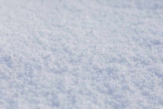 Close-up macro photo of graupel snow, also called soft hail, hominy snow, or snow pellet.