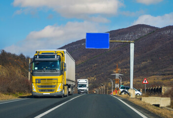 Fototapeta na wymiar Trucks on the road. Cargo trucks. Copy space. No logo, brand.