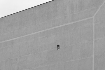 Small window in a large gray facade