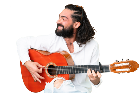 Young man with beard with guitar over isolated chroma key background