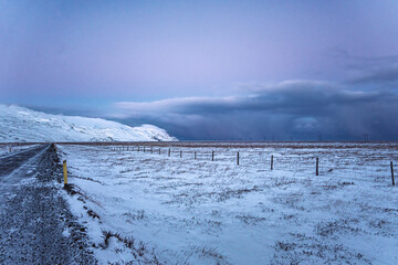 Iceland cloudy winter landscape road after sunset in Múlaþing