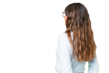 Young caucasian woman over isolated chroma key background in back position and looking back