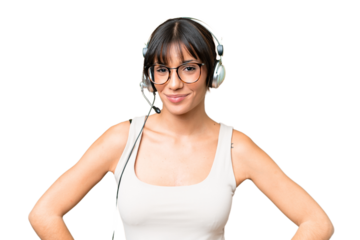Telemarketer caucasian woman working with a headset over isolated background posing with arms at hip and smiling