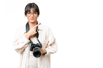 Young photographer caucasian woman over isolated chroma key background pointing to the side to present a product