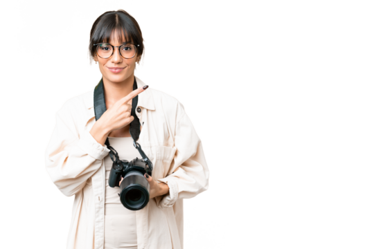 Young photographer caucasian woman over isolated chroma key background pointing to the side to present a product - Powered by Adobe