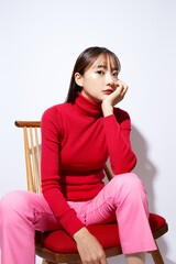赤いニットを着た若い女性のビューティー ポートレート