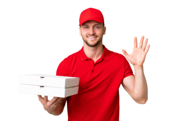 Pizza delivery man with work uniform picking up pizza boxes over isolated chroma key background saluting with hand with happy expression