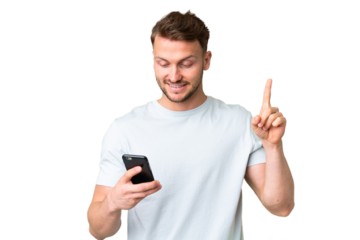 Young handsome caucasian man over isolated chroma key background using mobile phone and lifting finger