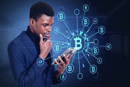 African businessman with tablet, bitcoin hologram icons and bloc