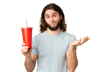 Young handsome man holding soda over isolated chroma key background making doubts gesture while lifting the shoulders