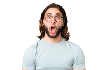 Young handsome man over isolated chroma key background With glasses and surprised expression